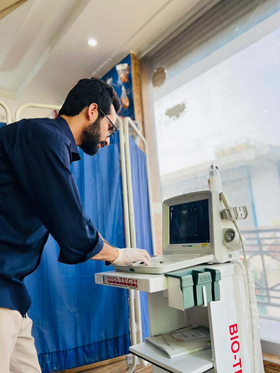 Vet doctor operating ultrasound machine at Dr Asim Pets Care Hospital